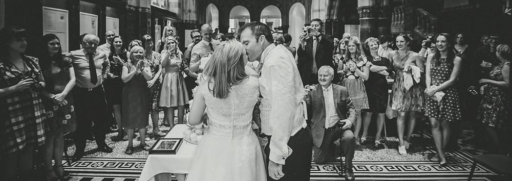 A couple celebrating their wedding surrounded by happy guests at the Victoria Gallery & Museum.