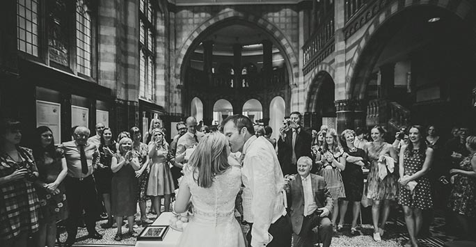 A couple celebrating their wedding surrounded by happy guests at the Victoria Gallery & Museum.