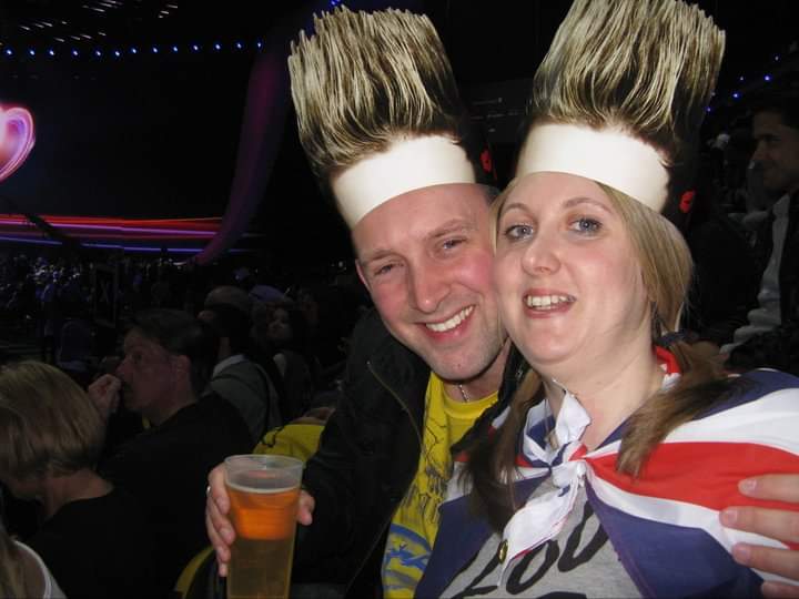 A man and woman wearing celebration hats