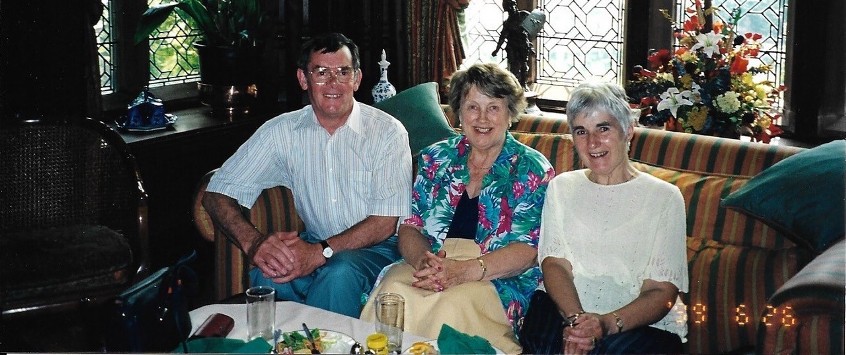 A group of three sitting on a sofa