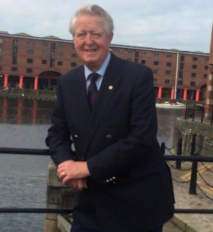 man in jacket standing by dockside