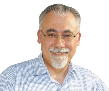 man with glasses and beard in blue and white striped shirt