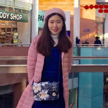 woman in pink coat and beret in shopping centre