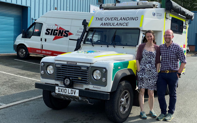 Alumnus Lawrence Dodi and partner Rachel Nixon stand next to their converted ambulance