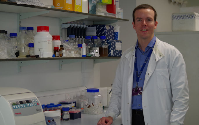 Paul Gilmore stands in laboratory 