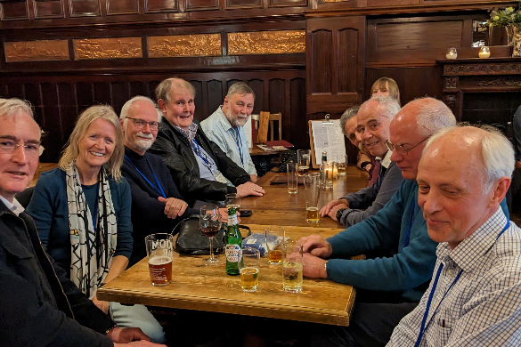 Alumni sitting around a table at a local pub