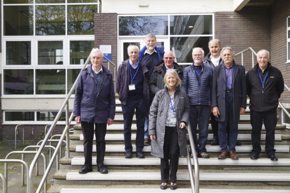 Alumni posing on the steps of the Life Sciences building