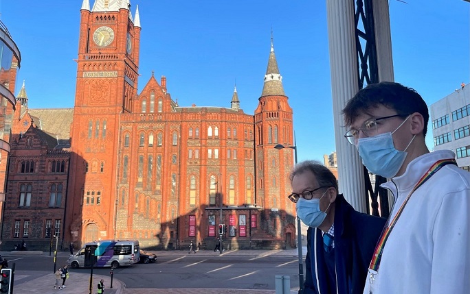 Chris Graham and Bertie Woodcock overlooking University Square with the red brick Victoria Building in the background