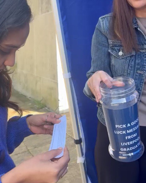 Student taking a message from a jar and reading it