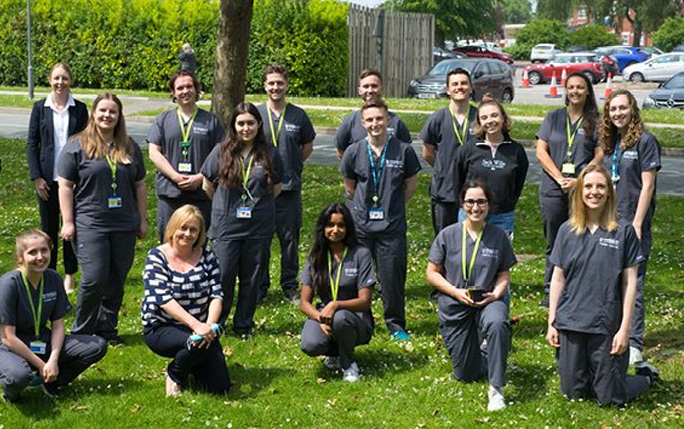 School of Medicine Classes of 2020 and 2021 pose for a photograph outdoors