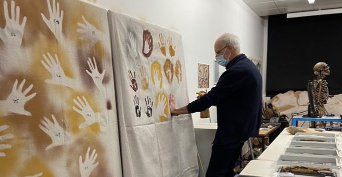 Graduate leaves handprint on wall