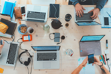 People working on laptops on a table