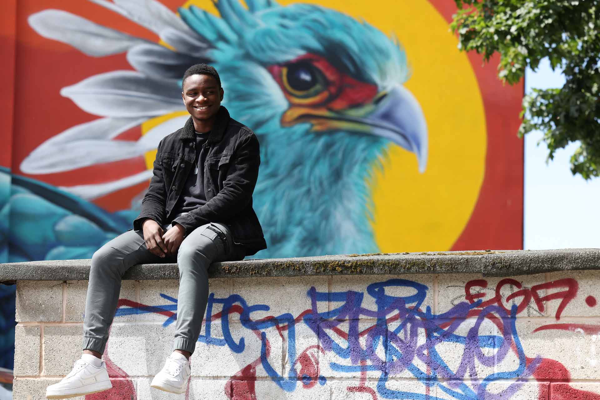 Student sitting on a wall