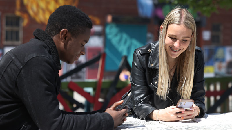 Two student on mobile phones