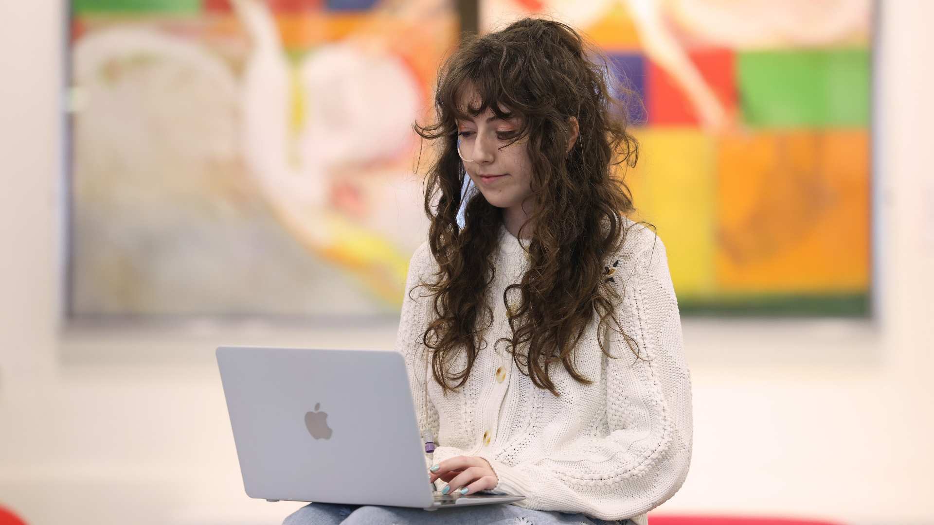 Student sitting and working on a laptop