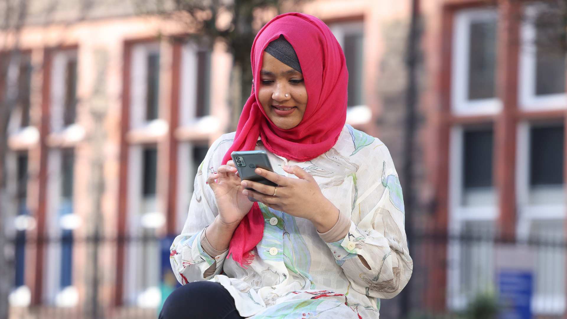 A students looking at her phone on campus