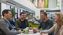 Students Talking at Coffee Shop Table