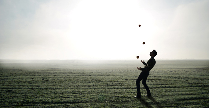 Man juggling on beach