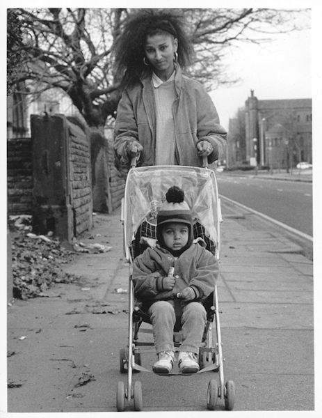 Mother with a child in a buggy.