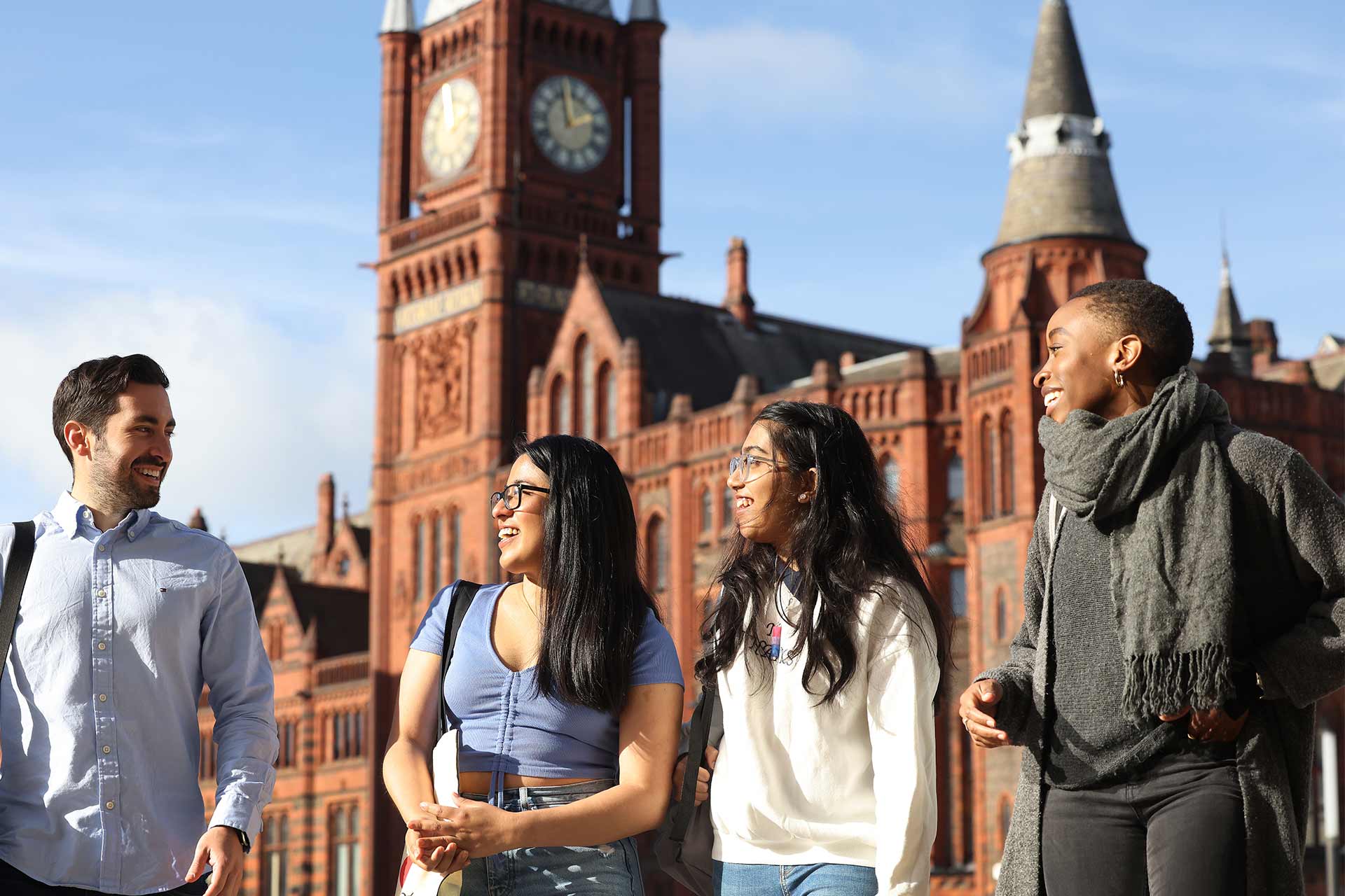 Students smiling and walking together outside campus buildings