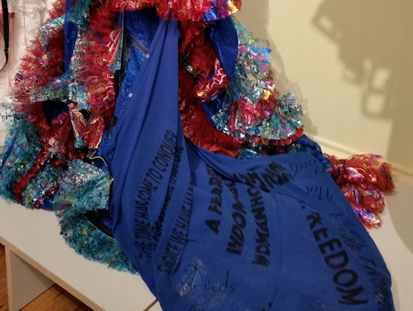 Detail of a blue dress covered in slogans