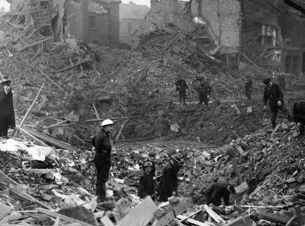 Men scouting a bombed area in Crosby after the May Blitz.