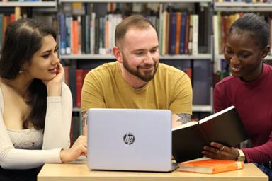 Three students at a desk