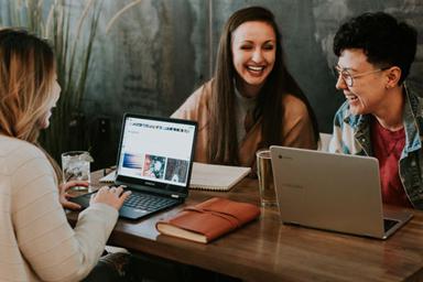 Three students laughing