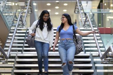 Two students on a staircase