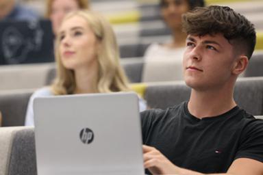 Two students in a lecture theatre