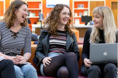 Three students laughing