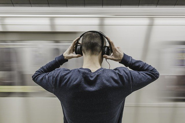 Person with headphones in subway