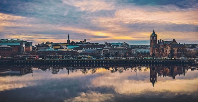 cityscape of belfast at sunset wih river in foreground