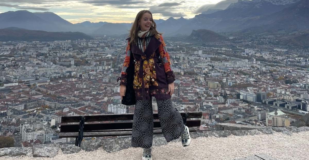 Image of a student standing on top of a hill