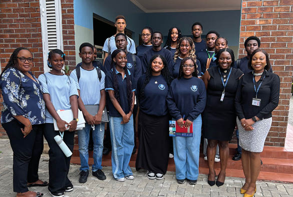 A group of students outside a school with Fola.