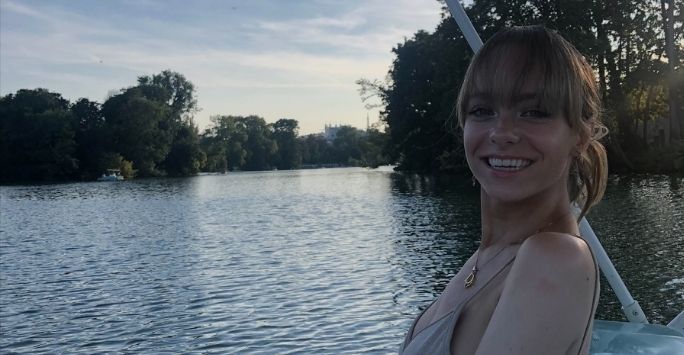 Photograph of Sarah in a boat on a lake.