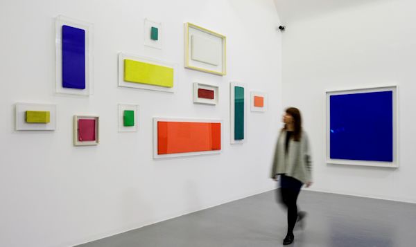 Multi-coloured paintings in a gallery