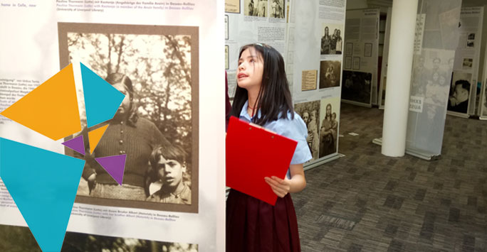 A school aged girl examining an image at an exhibition