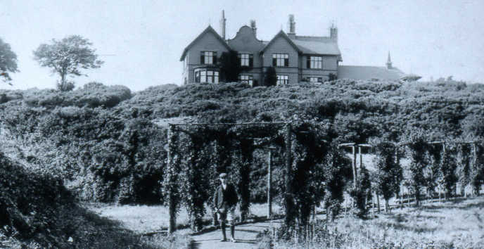 A gardener standin in the rock garden below Mickwell Brow, Ness Gardens early 20th Century