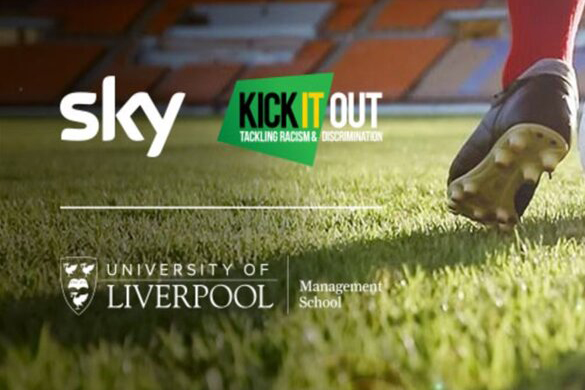 Close up of a footballer's boot as they're running on a football pitch in a stadium.