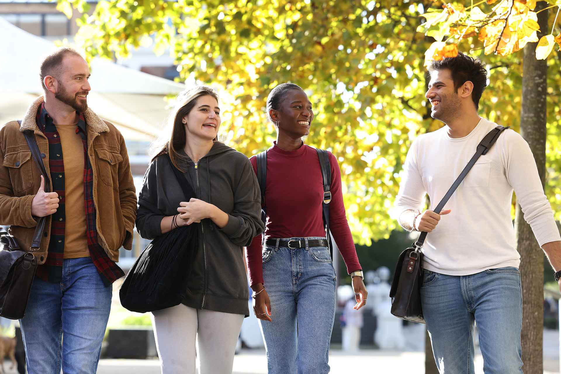 Four students walking on campus.