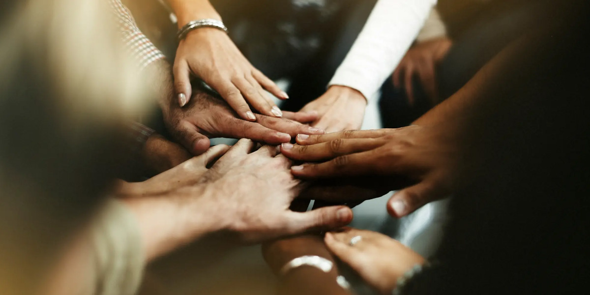 A group of people join their hands together