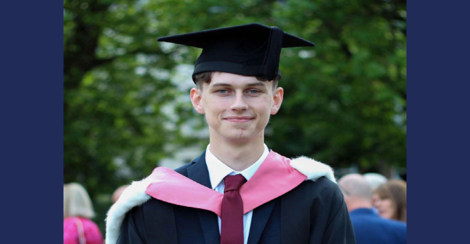 A headshot of Daniel Tagg in his Graduation Hat