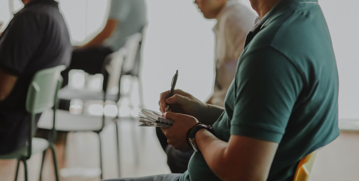 A close up of a student taking notes in a lecture