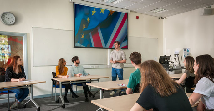 Dr Alex Mackenzie with students in class