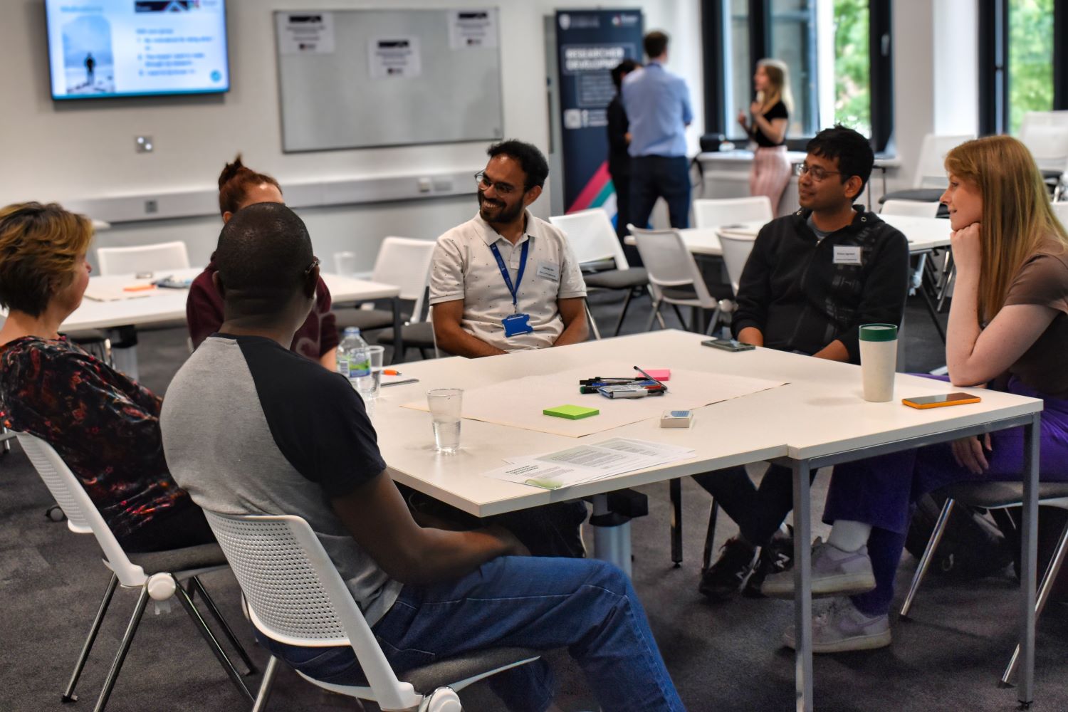 A group of researchers discussing their future career and research plans.