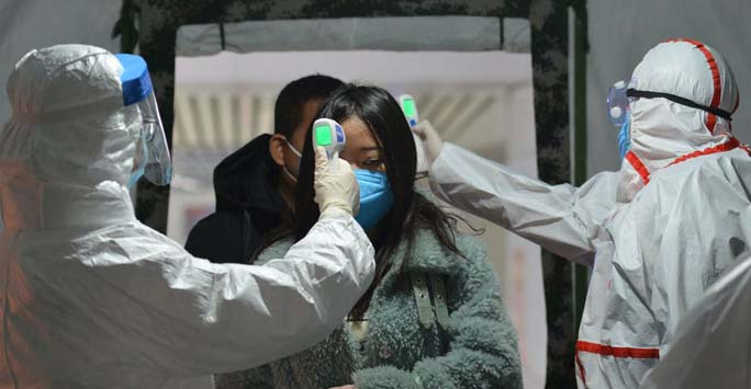 Woman having temperature taken