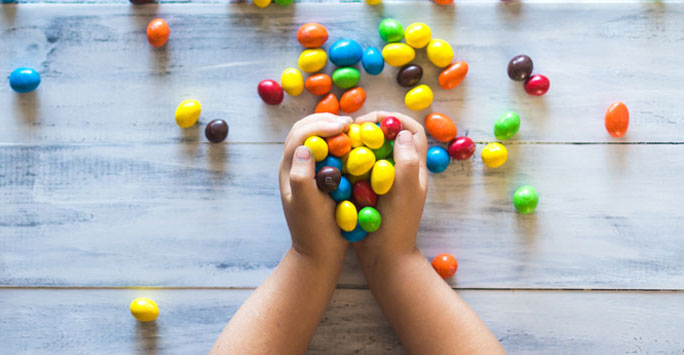 Child's hands full of sweets