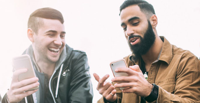 Two men looking at a phone