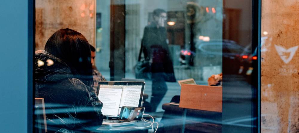 Photo of person with laptop and phone